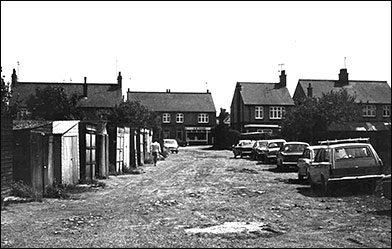 garges and cars along the track