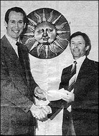 George receives a cheque for the club