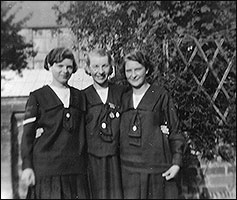 Ada is in between two friends, wearing their GLB uniform